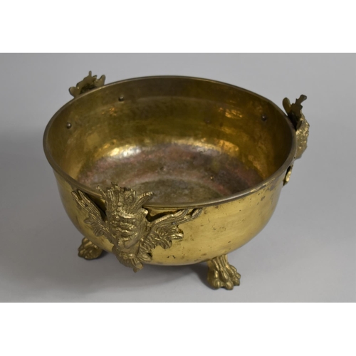 101 - A Beaten Brass Circular Bowl in the French Style with Maiden Mounts and Claw Feet, 26cm Diameter