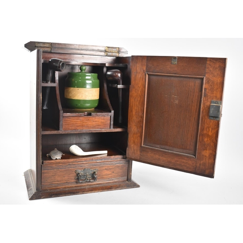 13 - An Edwardian smoker's cabinet given as an athletics prize in 1912, panelled door to fitted interior ... 