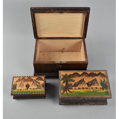 14 - A Collection of three graduated decorated East European boxes, the largest 22cm wide.