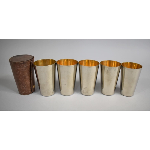 27 - A Vintage Leather Cased Set of Five Stacking Drinking Cups, the Case Monogrammed HTE, 14cm high