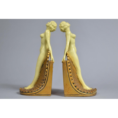 36 - A Pair of Cast Resin Art Deco Style Bookends in the Form of Two Nudes Standing on Shells, 24cm high