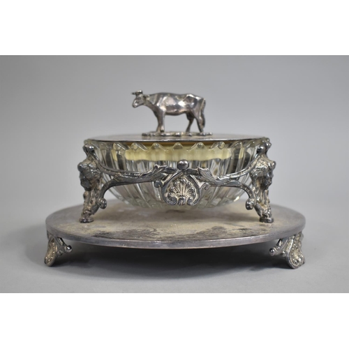 41 - An Edwardian Silver Plate and Glass Lidded Butter Dish with Cow Finial and Three Scrolled Feet, 19cm... 