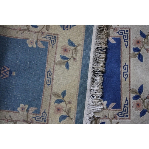 427 - A Chinese Patterned Woollen Rug on Blue Ground, 140x71cm