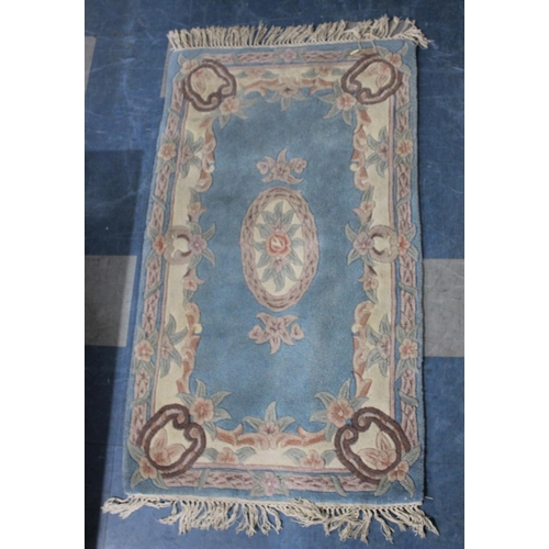 428 - A Chinese Patterned Woollen Rug on Blue Ground, 154x89cm