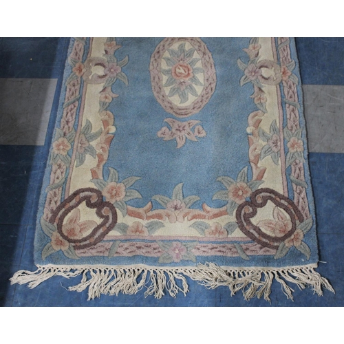 428 - A Chinese Patterned Woollen Rug on Blue Ground, 154x89cm