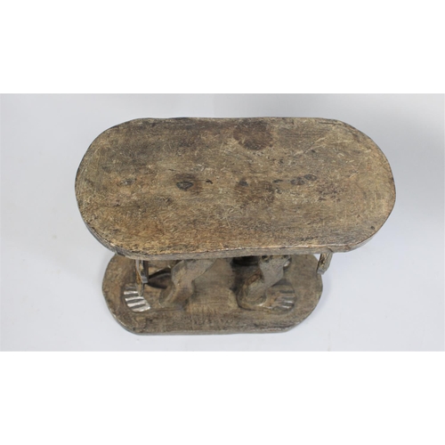 77 - An African Carved Wooden Souvenir Stool, the Supports in the Form of Elephant with Human Legs, Oval ... 