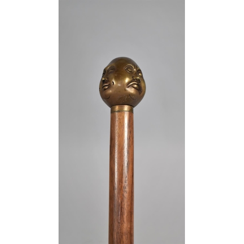 131 - A Modern Turned Wooden Walking Cane with Bronze Four Sided Buddha Handle