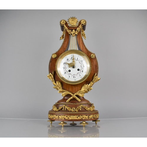 65 - A French Ormolu Mounted Kingwood Cased Lyre Mantel Clock in the Louis XVI Style, Enamelled Dial and ... 