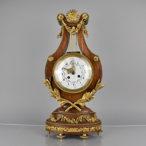 65 - A French Ormolu Mounted Kingwood Cased Lyre Mantel Clock in the Louis XVI Style, Enamelled Dial and ... 