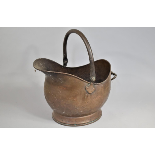 72 - A Mid 20th Century Copper and Brass Helmet Shaped Coal Scuttle, 46cms High