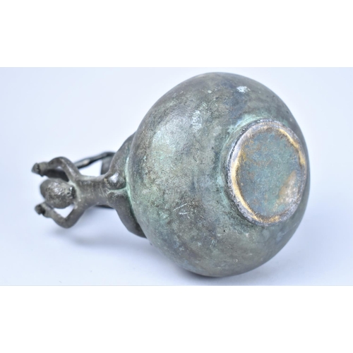 12 - A Patinated Bronze Jug, Handle in the Form of Young Gymnasts, 19cms High