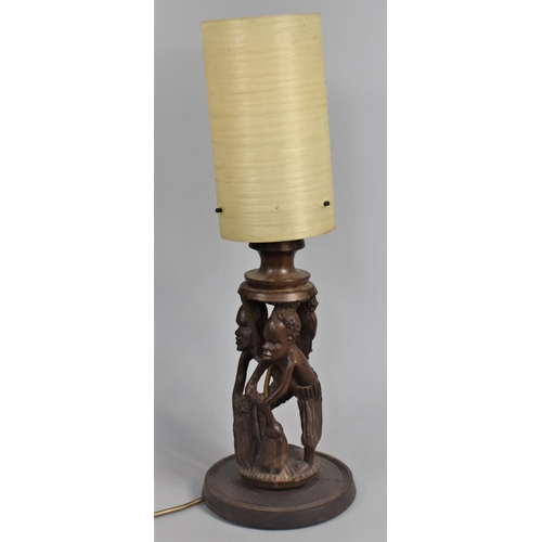 40 - A Carved African Souvenir Figural Table Lamp with Shade, 54cms High