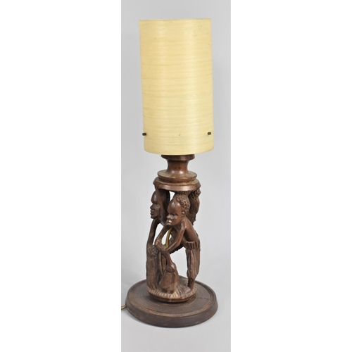 40 - A Carved African Souvenir Figural Table Lamp with Shade, 54cms High