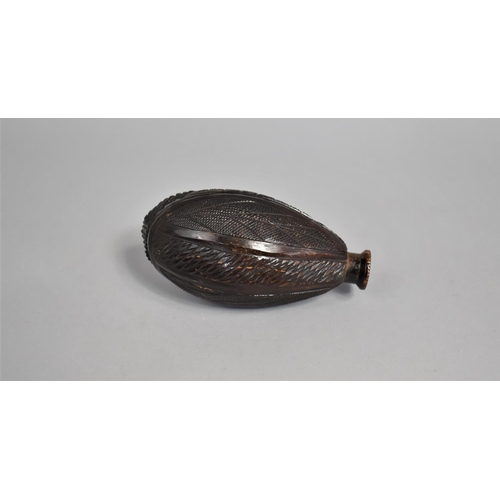 38 - A Far Eastern Coquilla Nut Flask of Ovoid Form, 13cms High