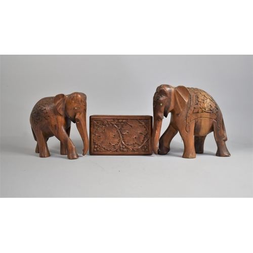 60 - A Carved Far Eastern rectangular Box and Two Similar Souvenir Elephants, 23cms High