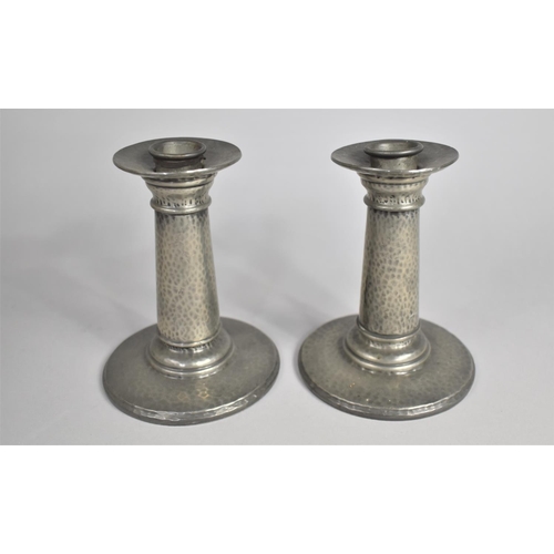 63 - A Pair of Hand Beaten Tudric Pewter Candlesticks with Removable Caps, As Made for Liberty and Co, No... 