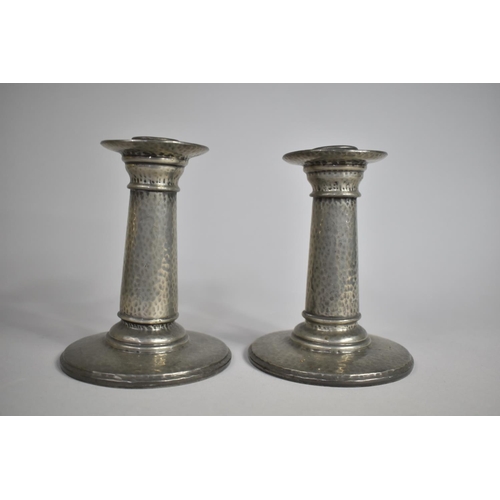 63 - A Pair of Hand Beaten Tudric Pewter Candlesticks with Removable Caps, As Made for Liberty and Co, No... 