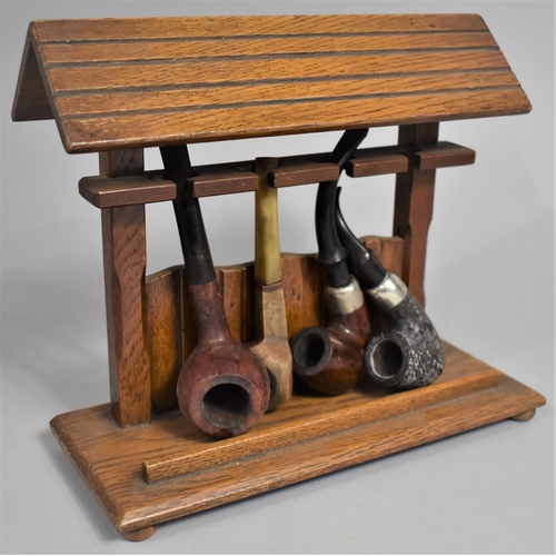 35 - A Mid 20th Century Novelty Four Section Pipe Rack Containing Four Vintage Pipes, 23cms Wide