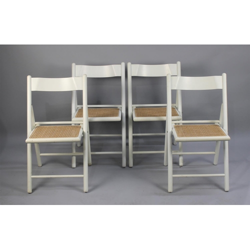 466 - A Set of Four Modern Cane Seated White Painted Folding Chairs