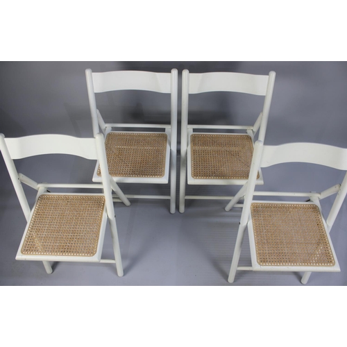 466 - A Set of Four Modern Cane Seated White Painted Folding Chairs