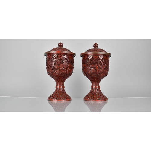 154 - A Pair of 19th/20th Century Cinnabar Pedestal Jars and Covers decorated with Figures in Exterior Set... 