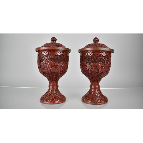 154 - A Pair of 19th/20th Century Cinnabar Pedestal Jars and Covers decorated with Figures in Exterior Set... 