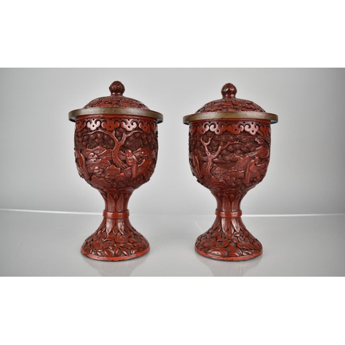 154 - A Pair of 19th/20th Century Cinnabar Pedestal Jars and Covers decorated with Figures in Exterior Set... 