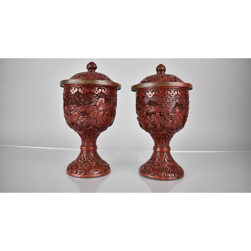 154 - A Pair of 19th/20th Century Cinnabar Pedestal Jars and Covers decorated with Figures in Exterior Set... 