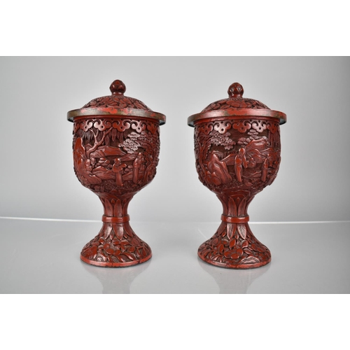 154 - A Pair of 19th/20th Century Cinnabar Pedestal Jars and Covers decorated with Figures in Exterior Set... 