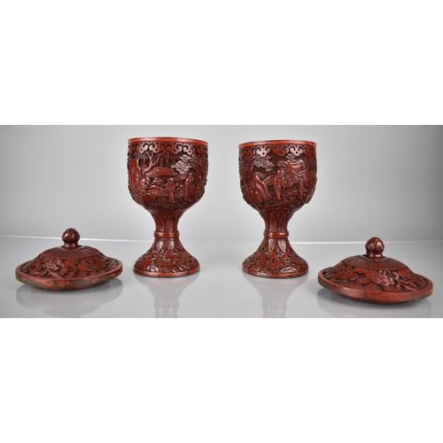 154 - A Pair of 19th/20th Century Cinnabar Pedestal Jars and Covers decorated with Figures in Exterior Set... 