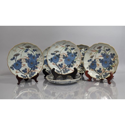 130 - A Set of Eight 19th Century Japanese Porcelain Plates decorated in Under Glazed Blue Blossoming Flow... 