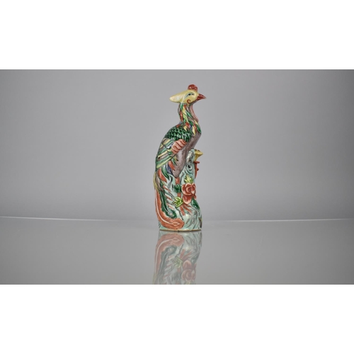 107 - A Chinese Porcelain Spill in the Form of a Phoenix decorated in Multi-coloured Enamels, 20.5cms High