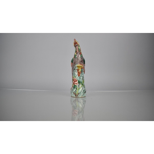 107 - A Chinese Porcelain Spill in the Form of a Phoenix decorated in Multi-coloured Enamels, 20.5cms High