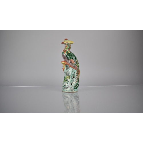 107 - A Chinese Porcelain Spill in the Form of a Phoenix decorated in Multi-coloured Enamels, 20.5cms High