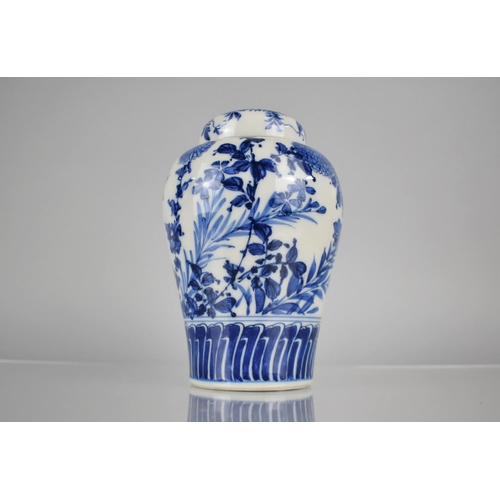 20 - A 20th Century Oriental Blue and White Porcelain Jar and Cover of Baluster Form decorated in a Flora... 