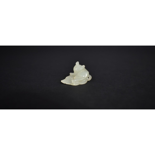 140 - A Chinese White Jade Pebble Carving of Cat Seated on Leaf, 3cms by 1cms High