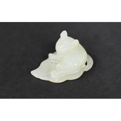 140 - A Chinese White Jade Pebble Carving of Cat Seated on Leaf, 3cms by 1cms High