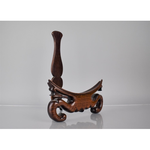 171 - A Good Quality Chinese Hardwood Plate Stand with Carved Scrolled Design, 24cms Wide and 31.5cms High