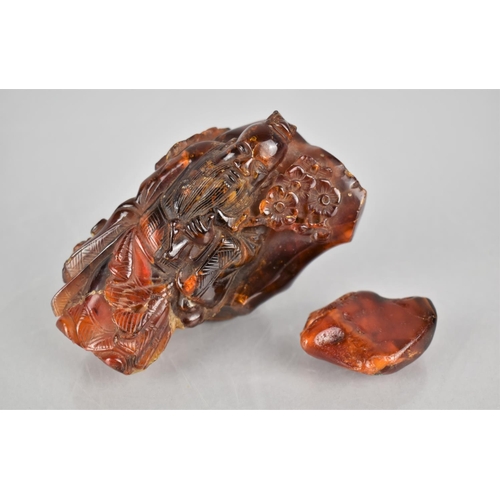 133 - A Chinese Carved Piece of Amber with Immortal, 9cms High together with Piece of Raw Amber, 4cms High... 