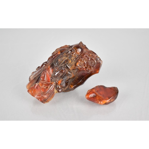 133 - A Chinese Carved Piece of Amber with Immortal, 9cms High together with Piece of Raw Amber, 4cms High... 