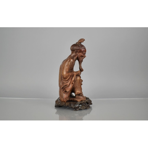 162 - A 19th Century Carved Hardwood Figure of an Emaciated Holy Man Wearing a Wide Brimmed Hat and Flowin... 