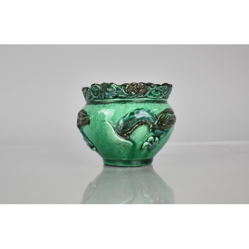 108 - A Chinese Pottery Green Glazed Pot decorated in Relief with Dragon, 6.5cms High