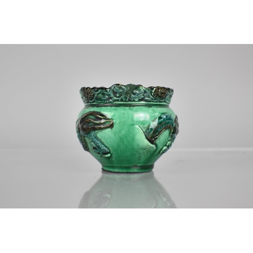 108 - A Chinese Pottery Green Glazed Pot decorated in Relief with Dragon, 6.5cms High