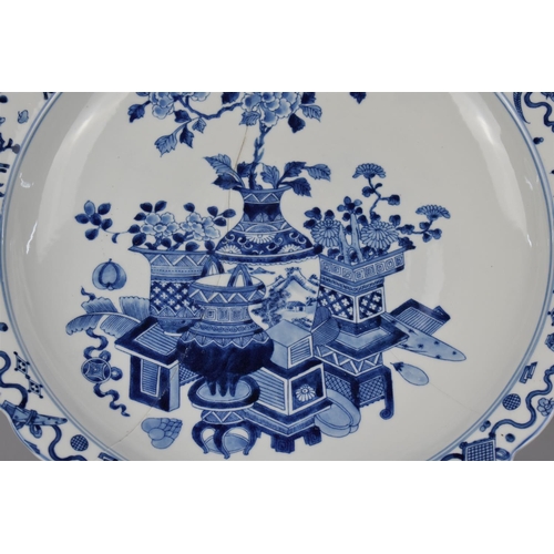 7 - A Large Chinese Porcelain Blue and White Charger decorated with Antique Vases of Flowers, Precious O... 