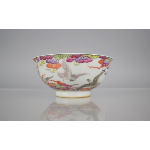 67 - A Chinese Porcelain Bowl Decorated in the Famille Rose Palette with Birds in Flight Amongst Clouds, ... 