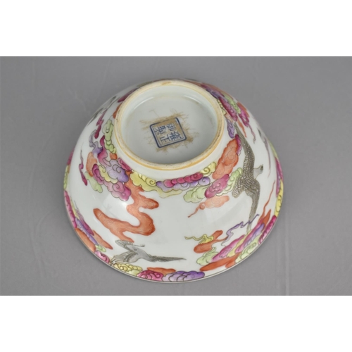 67 - A Chinese Porcelain Bowl Decorated in the Famille Rose Palette with Birds in Flight Amongst Clouds, ... 