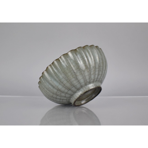 121 - A Chinese Celadon Crackle Glazed Bowl of Reeded Form, 19cms Diameter, 8cms High