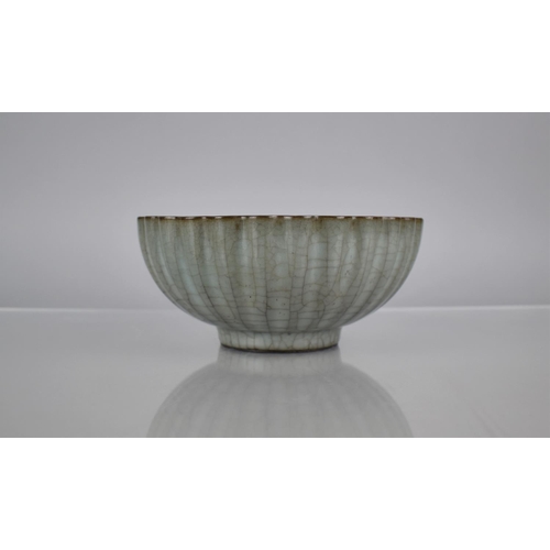 121 - A Chinese Celadon Crackle Glazed Bowl of Reeded Form, 19cms Diameter, 8cms High