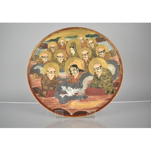 128 - A Japanese Meiji Period Satsuma Charger decorated with Immortals and White Dragon, 26cms Diameter