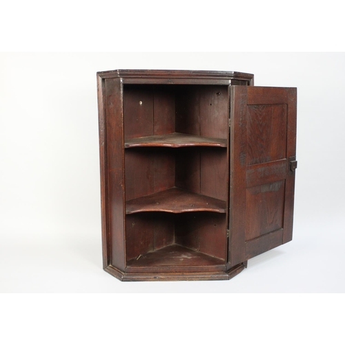 365 - An 18th Century Oak Corner Cupboard with a Twin Panelled Door and Original Brass Hinges. 68cms Wide ... 